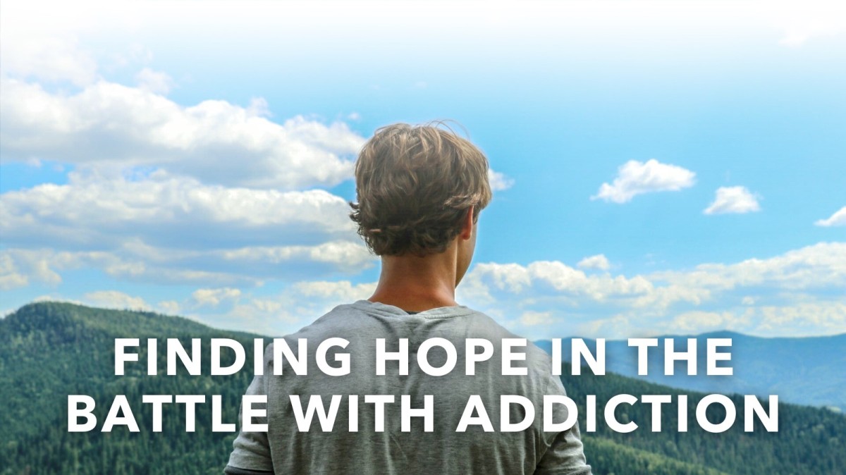 Individual standing in front of mountain landscape. Text reads: